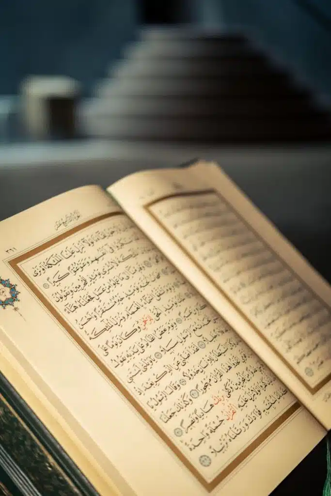 Close-up of an open Quran with Arabic script in a peaceful indoor setting.
