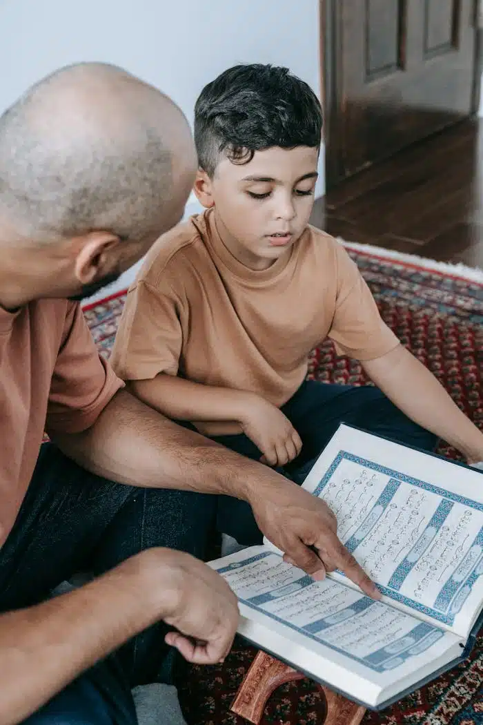 A father teaching his son to read the Koran, signifies Islamic faith and bonding.